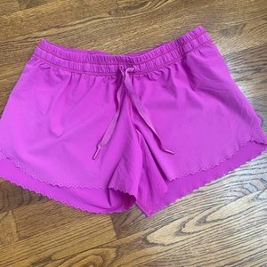 Size 8 lululemon fuschia shorts with scalloped edges